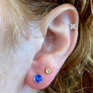 white gold tanzanites on ear