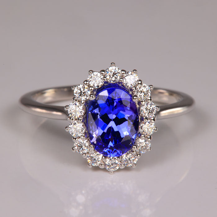 oval tanzanite in white gold ring with diamond halo 