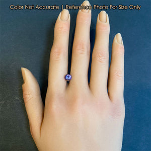 round brilliant cut tanzanite gemstone on a hand