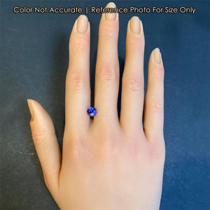 tanzanite gemstone oval cut violet blue on hand