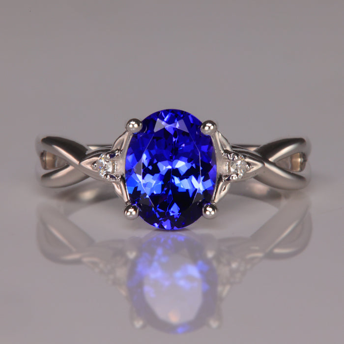 violet blue tanzanite gemstone in white gold ring with diamond accents