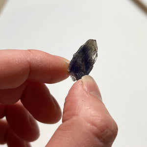 raw tanzanite crystal in hand