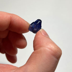 deep blue tanzanite in hand