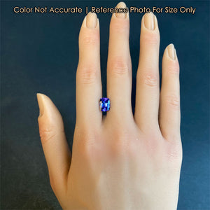 rare gemstone tanzanite on hand violet blue color
