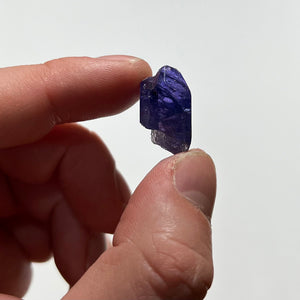 deep color tanzanite crystal in hand