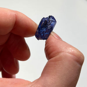 tanzanite crystal with deep color in hand