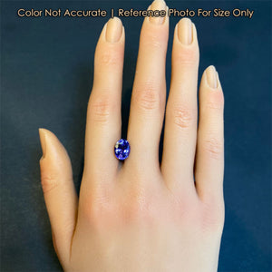 tanzanite gemstone on hand oval cut blue violet