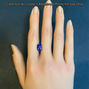 blue violet tanzanite gem on hand