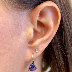 yellow gold tanzanite dangle earrings on ear