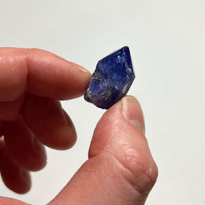 deep blue tanzanite in hand