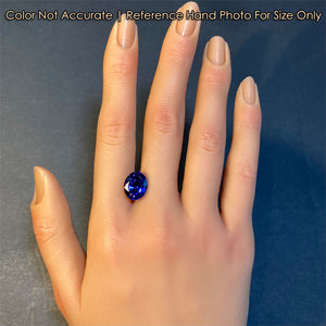 oval tanzanite gem on hand 