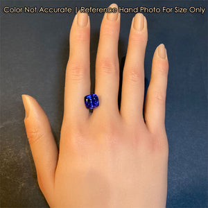 blue violet tanzanite gem on hand