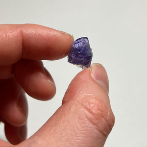 raw tanzanite in hand 