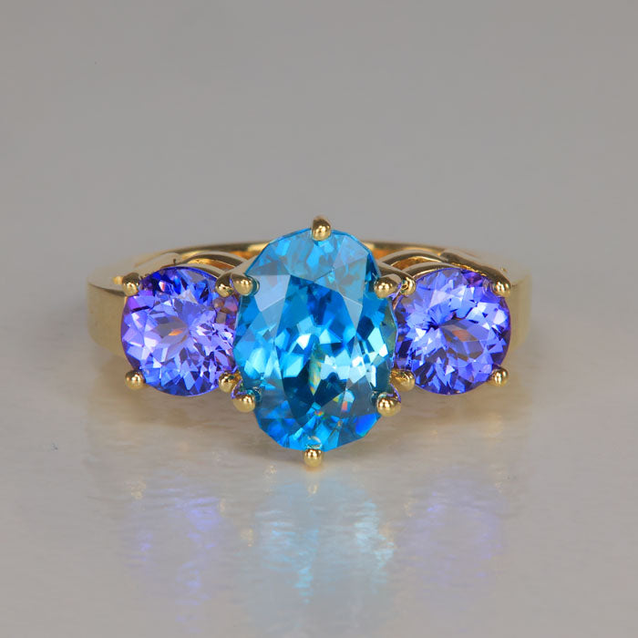 blue zircon ring with tanzanites in yellow gold