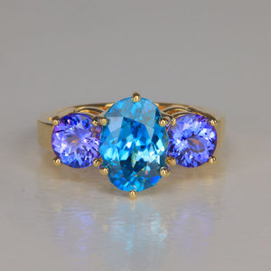 blue zircon ring with tanzanites in yellow gold