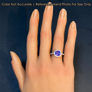 tanzanite gemstone ring on hand in white and yellow gold 