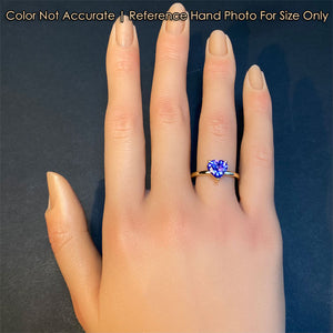 tanzanite ring in yellow gold on hand