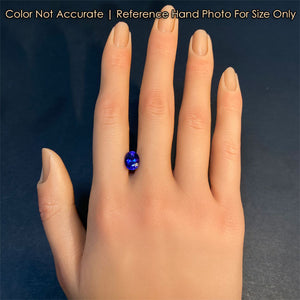 blue tanzanite gemstone on hand