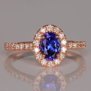 oval tanzanite gemstone ring with diamond halo in rose gold