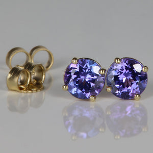 blue violet tanzanite gemstone stud earrings in yellow gold