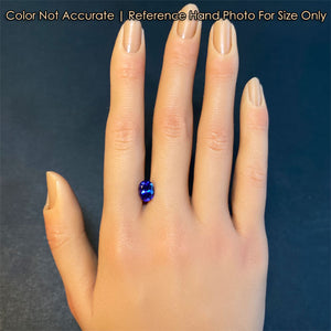 oval tanzanite gem on hand