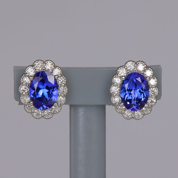 oval cut tanzanites with diamond halo in white gold stud earrings
