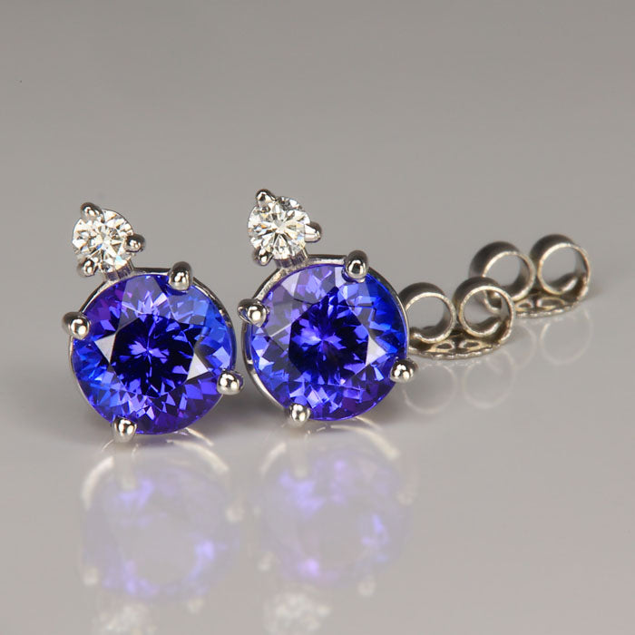 round brilliant tanzanite gemstone earrings with diamonds in white gold 