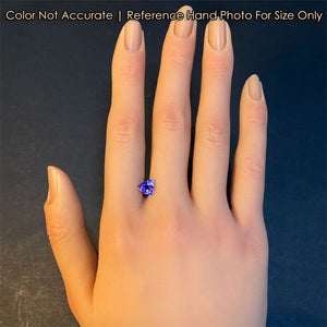 tanzanite gemstone trilliant cut violet color on hand for size