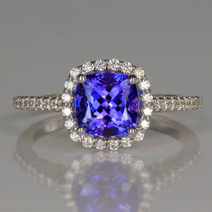 square cushion cut tanzanite gem in white and yellow gold ring with diamond accents 