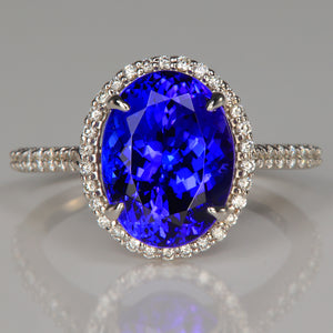 oval cut large tanzanite gemstone in 18k white gold ring with diamond accents