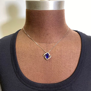 oval tanzanite white gold  diamond swirl  pendant